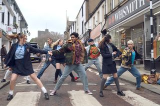Greatest Days cast dancing in the street