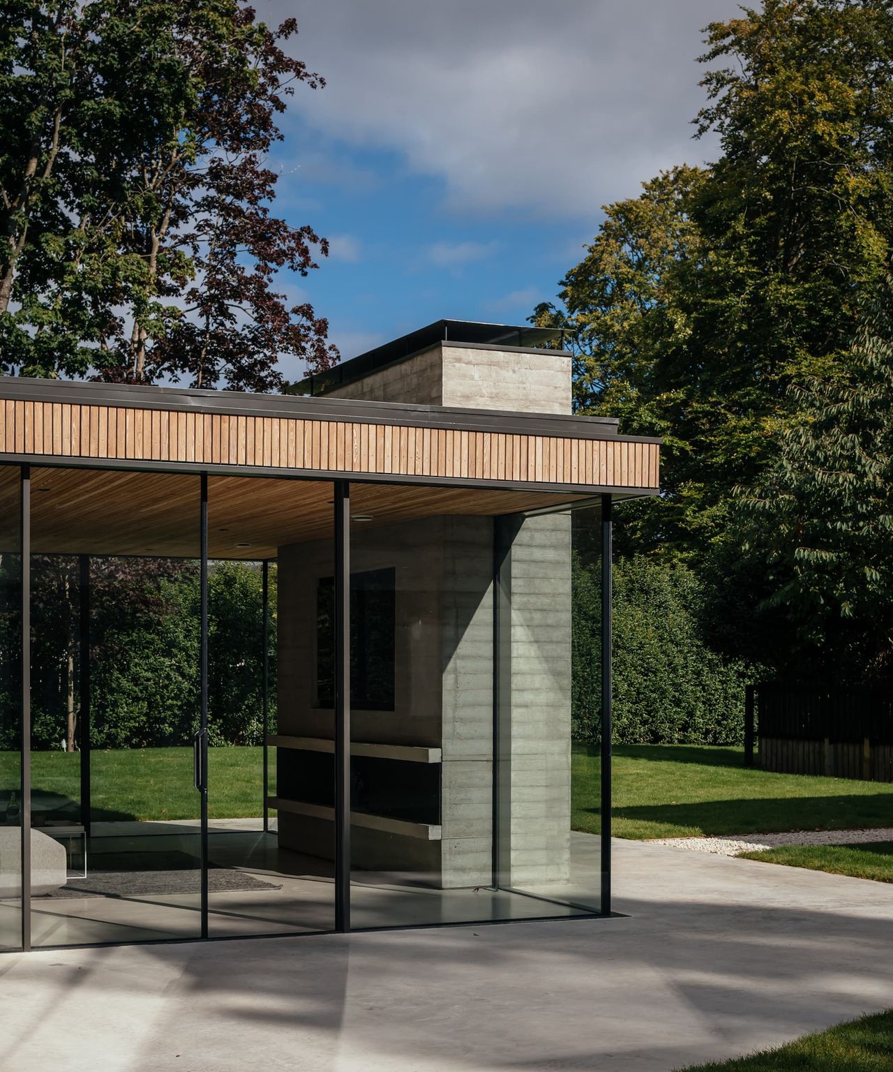 A garden room with glass walls and larch cladding