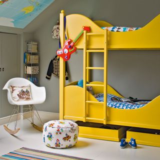 Grey attic bedroom with yellow bunk bed