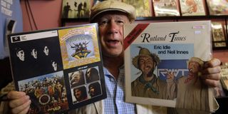 Neil Innes with a Beatles record and a Rutland record in hand