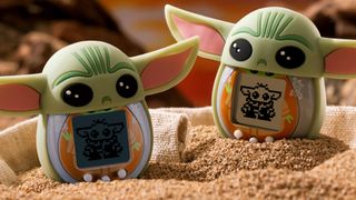 Star Wars Grogu Tamagotchi designs on sand, with silicone Baby Yoda covers