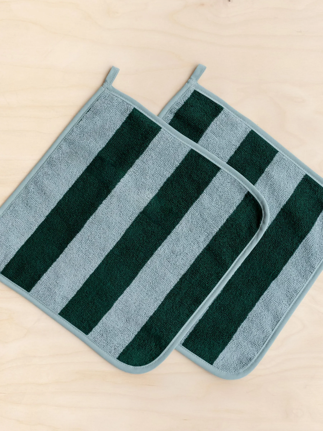 A set of green striped face towels