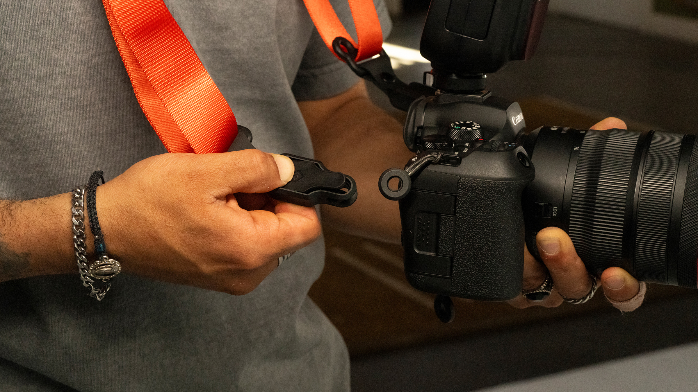 The Wandrd Magnetic Camera strap being used by a photographer