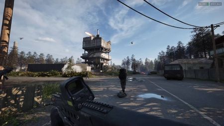 Wardogs player and teammate running towards drill tower with helicopter flying nearby