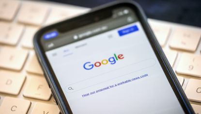 A link to Google's proposal to a workable news code on the company's homepage, arranged on an iPhone in Sydney, Australia, on Friday, Jan. 22, 2021. 