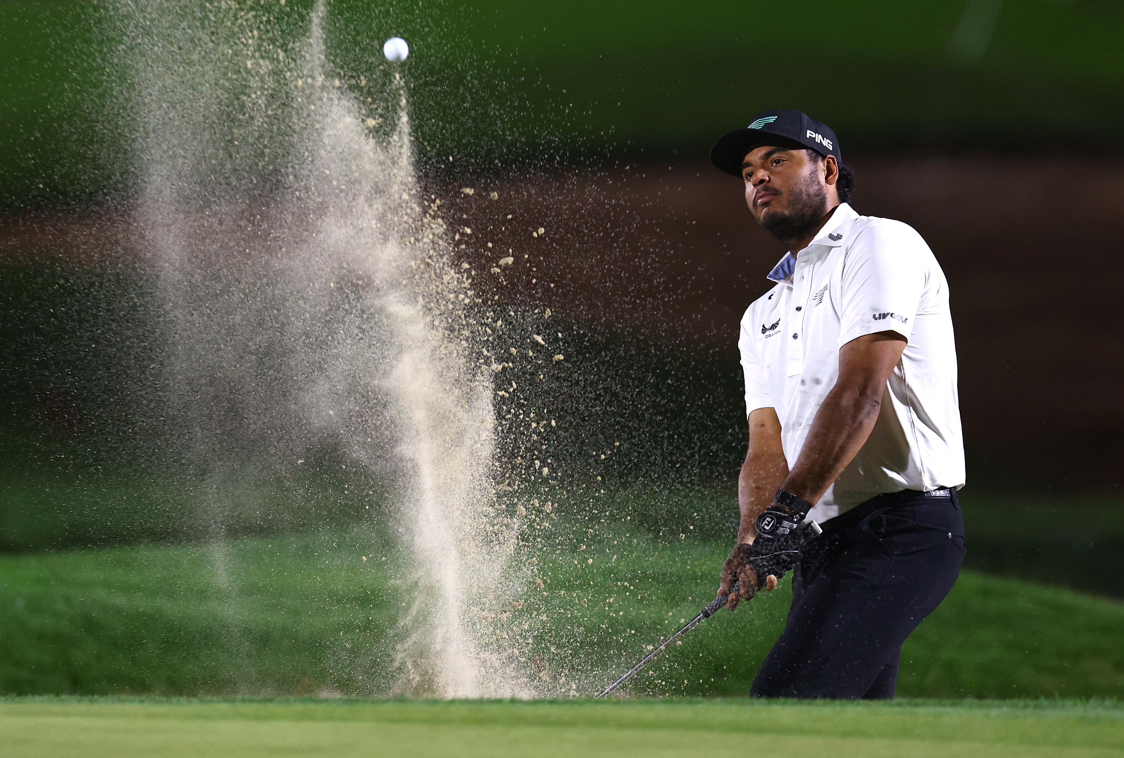Sebastian Munoz hits a bunker shot