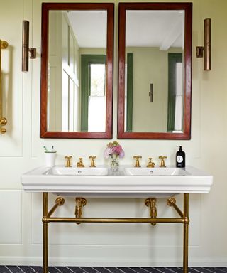 bathroom with pale walls, double vanity and wooden mirrors