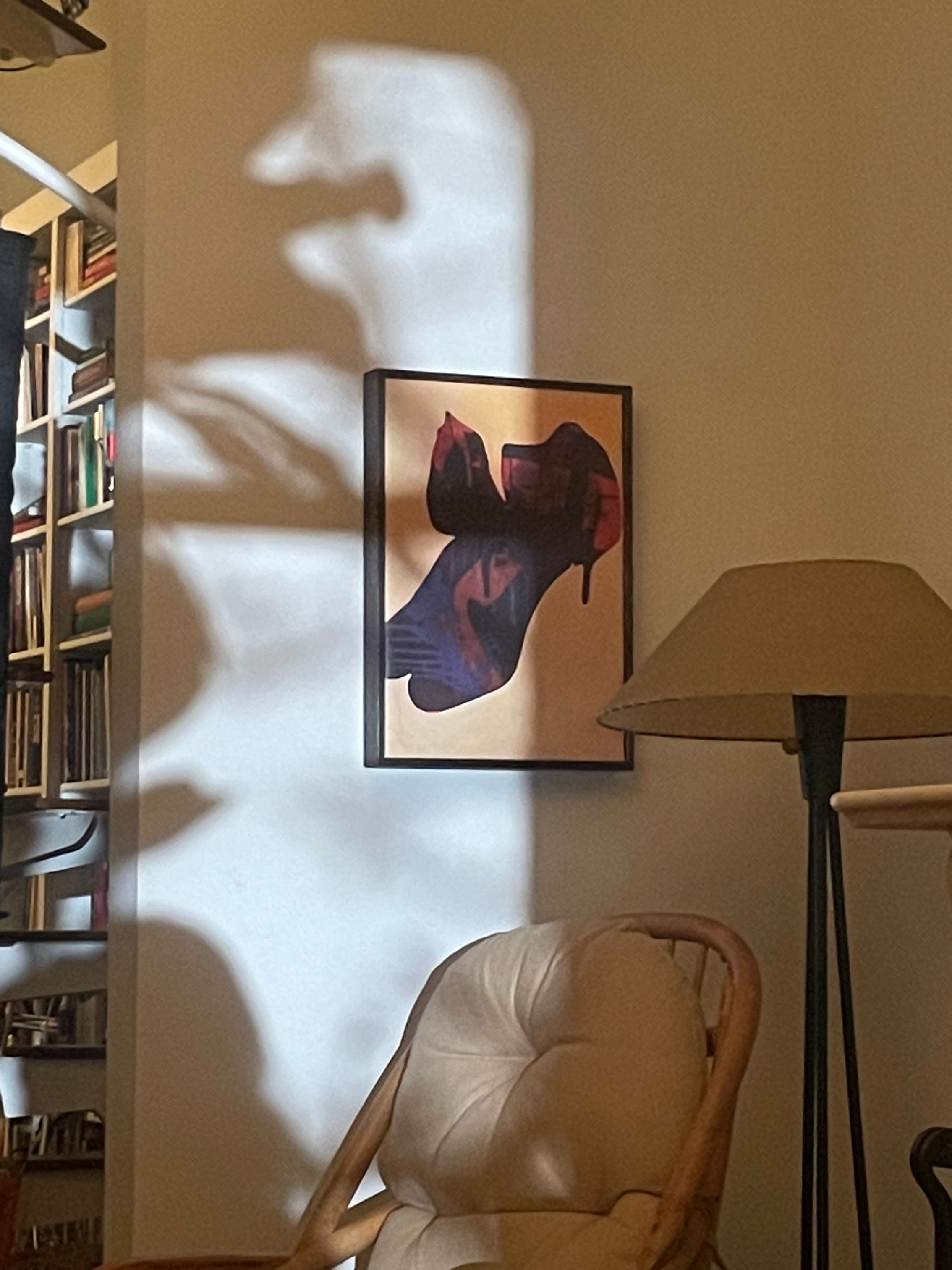 A series of interior shots of an art and objects-filled, dimly lit apartment, a museum's gallery rooms, an empty dance rehearsal room, and colorfully decorated office spaces.