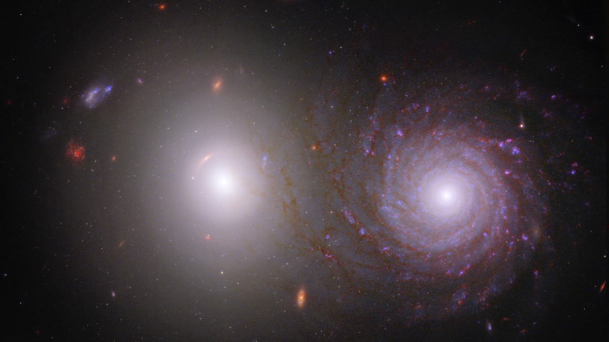 two spiral galaxies side by side in deep space