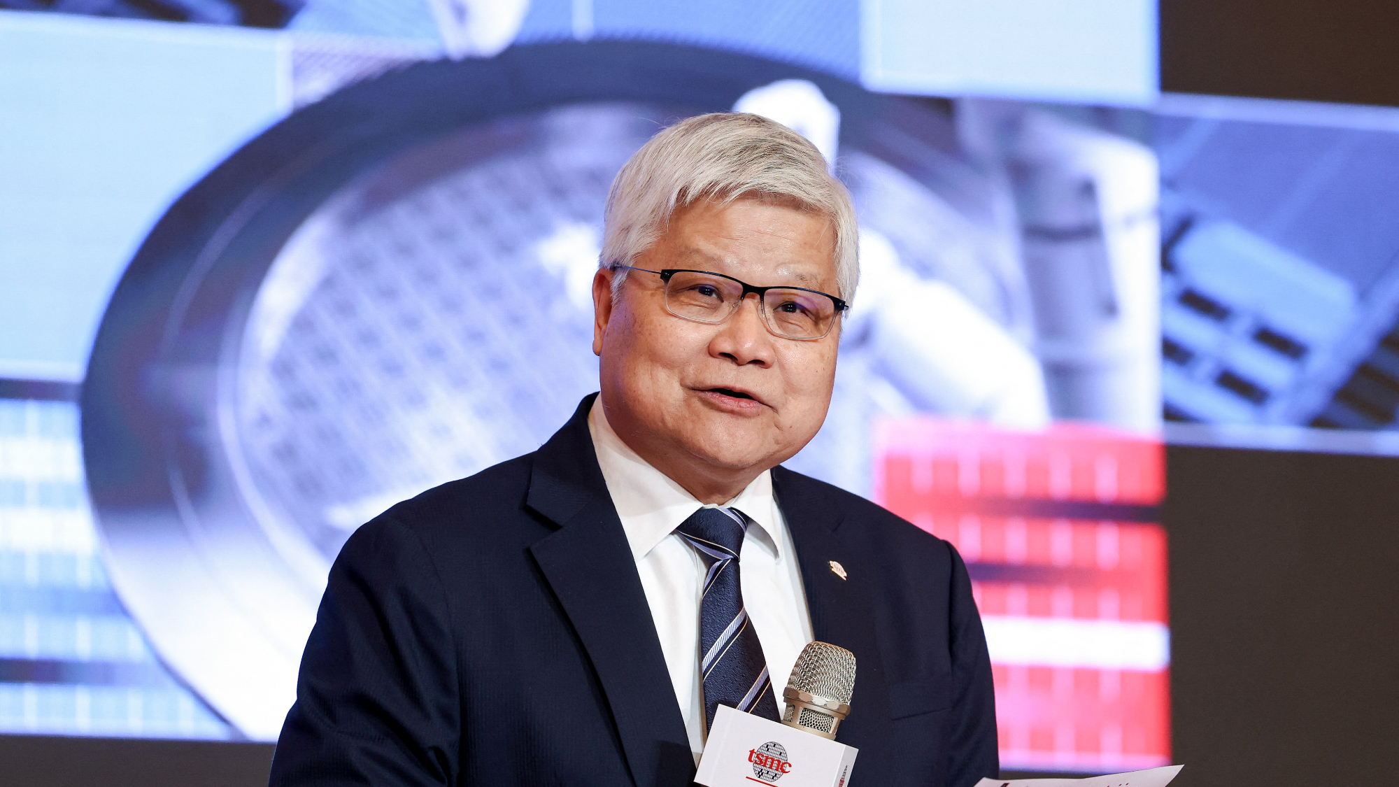 CC Wei at the TSMC shareholders meeting holding a microphone