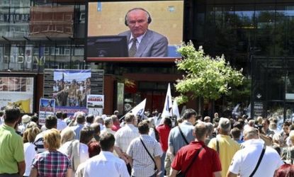 A crowd watches the court proceedings of former Bosnian Serb army chief Ratko Mladic in Sarajevo last year