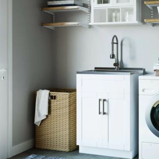 A cabinet sink in a laundry room