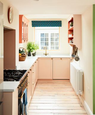 peach shaker style kitchen with wooden flooring