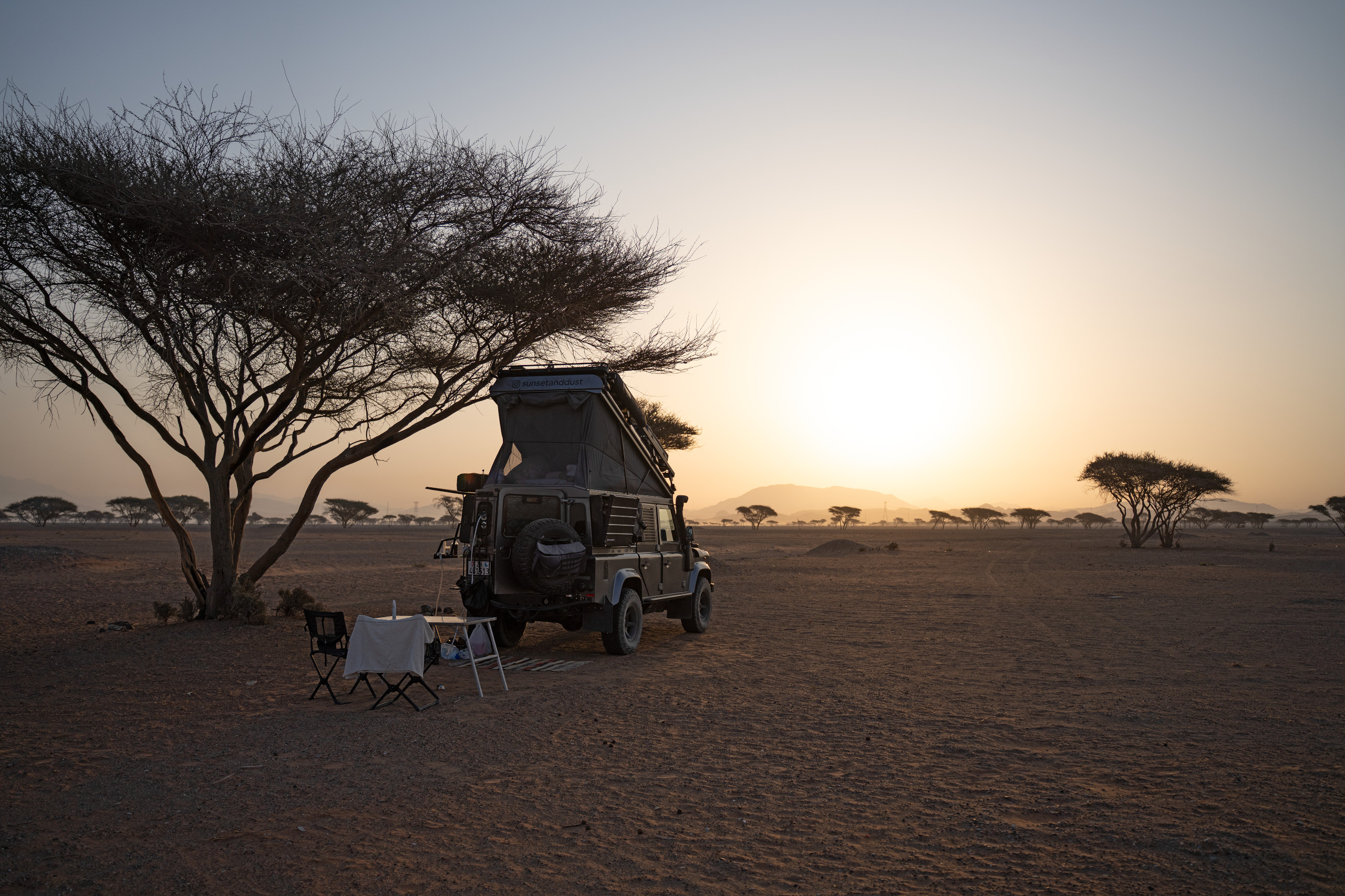 Land Rover Defender 110 Tdci 2.4 in sunset and dust, camping trip