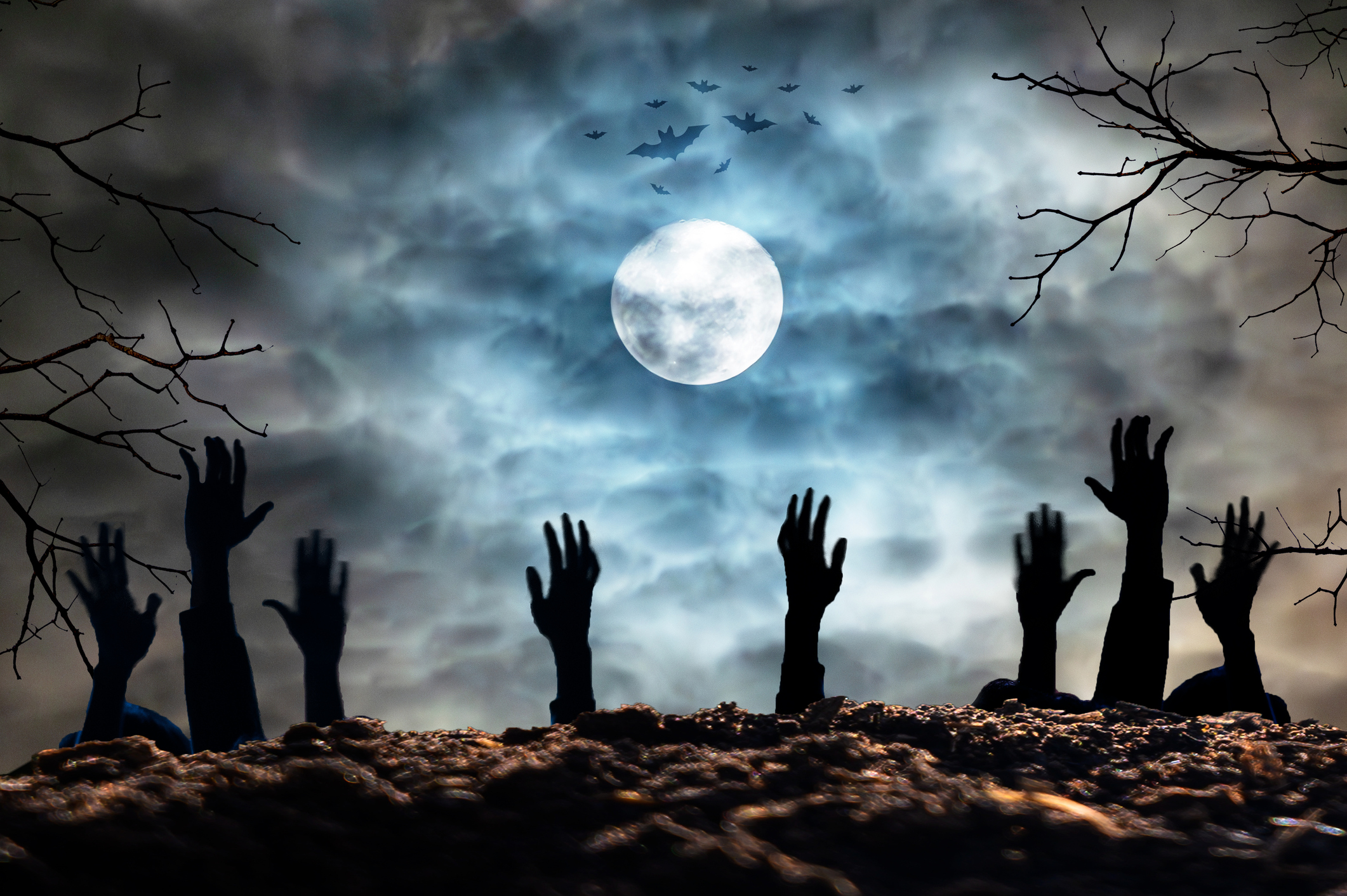 Zombie hands coming out of graves.