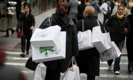 Shoppers heft bags in Manhattan on Black Friday November 27, 2009. This year retailers like Sears and Amazon are kicking off the discount season a month earlier.