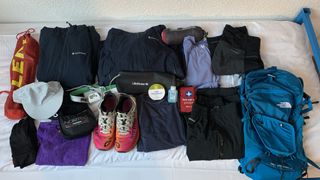 Trail running kit spread out on a bed