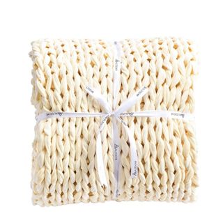 A cream knitted blanket