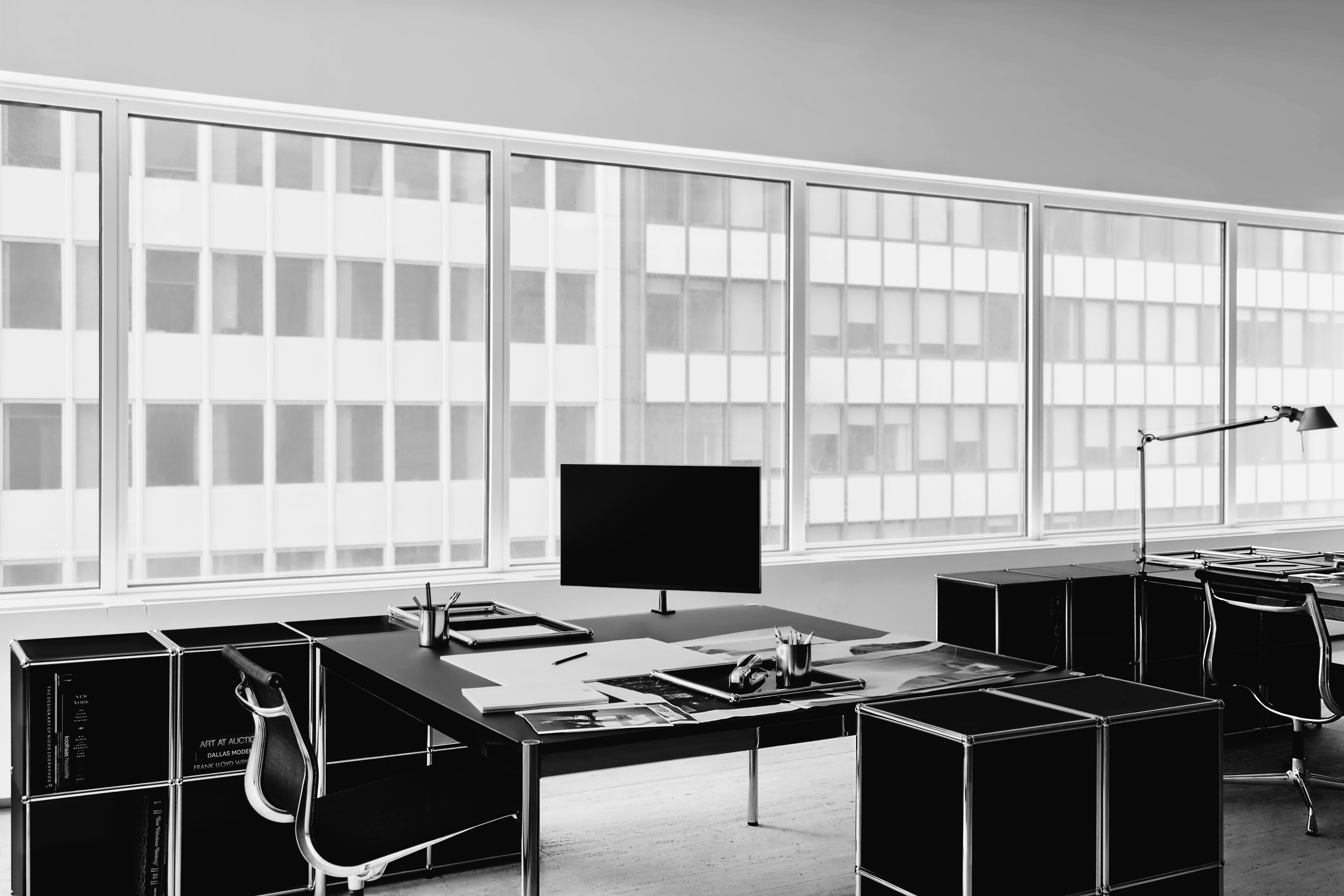 Black and white office space furnished with USM Haller system