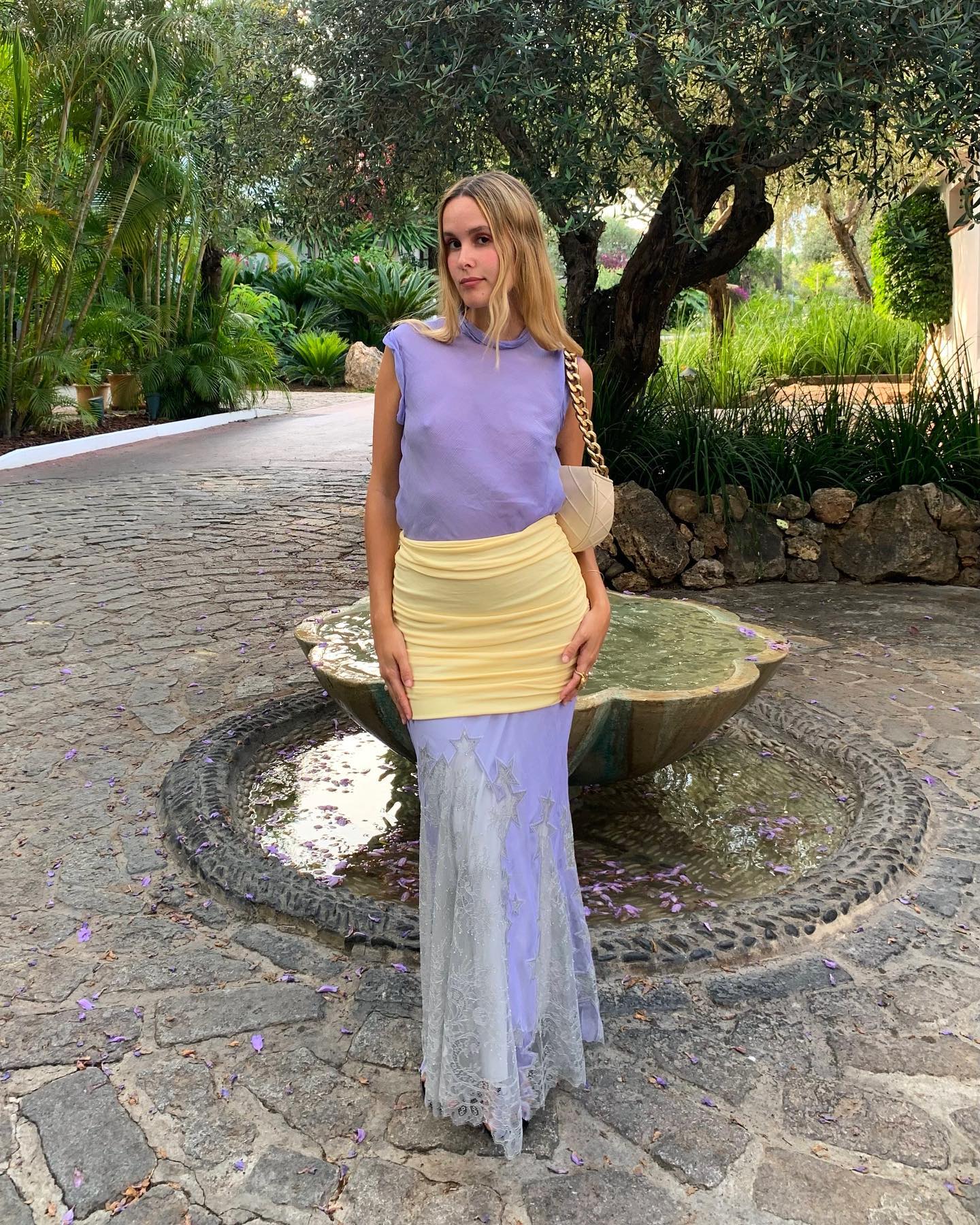 Lucia Cuesta wearing a lavender top and skirt from Tory Burch.