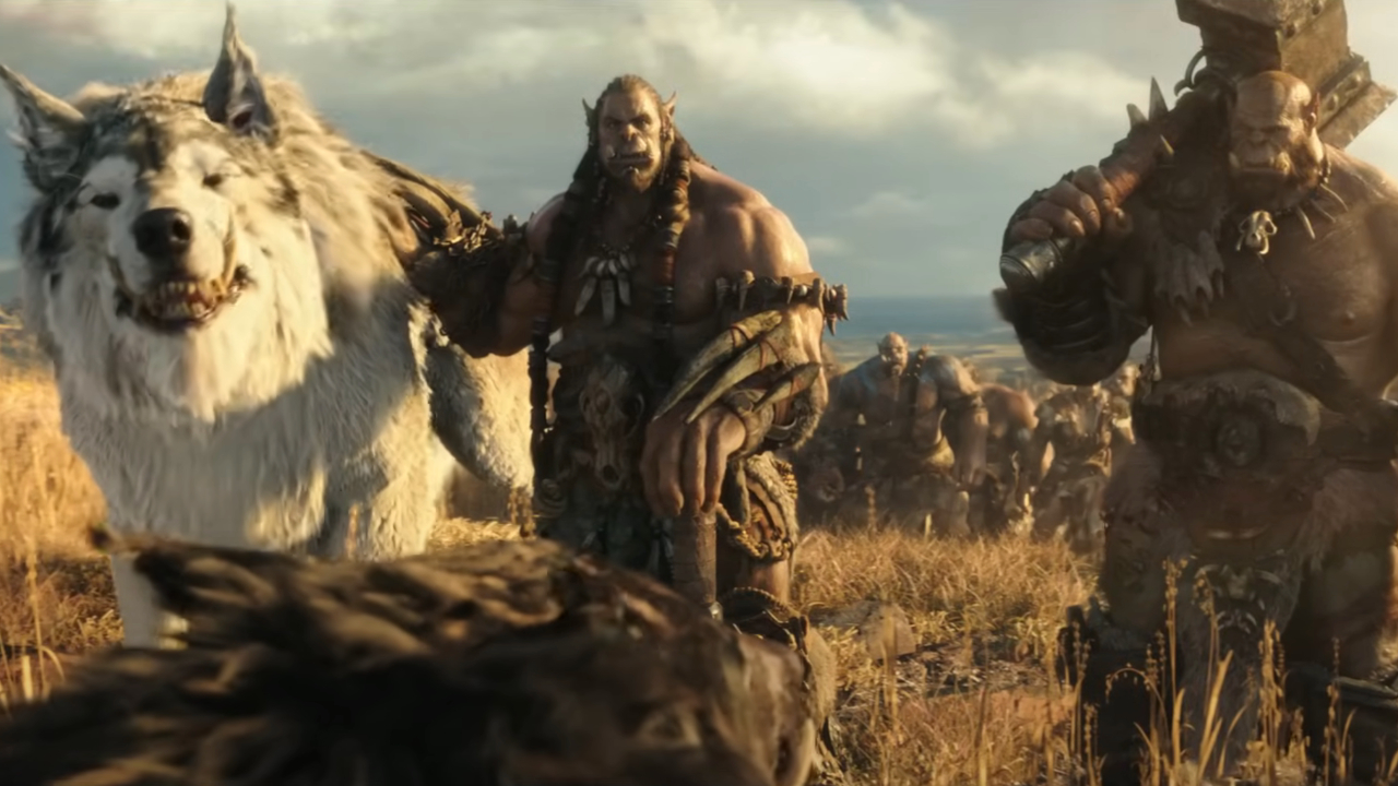 A gigantic wolf stands with two Orcs in a well lit field in Warcraft.