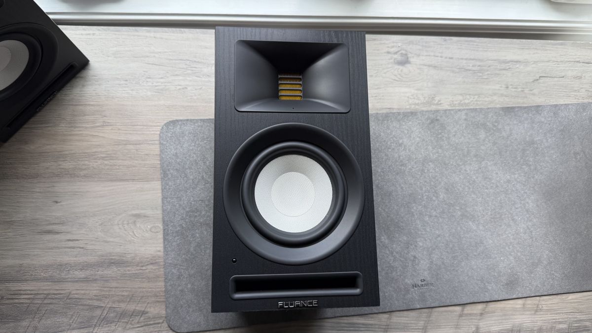 Front panel of the Fluance Ri71 powered bookshelf speaker, placed on its back on a white surface.