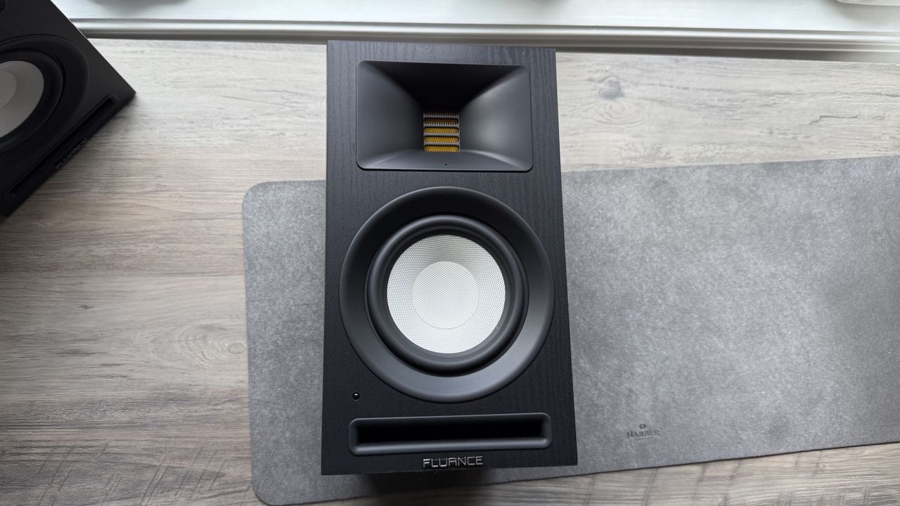 Front panel of the Fluance Ri71 powered bookshelf speaker, placed on its back on a white surface.
