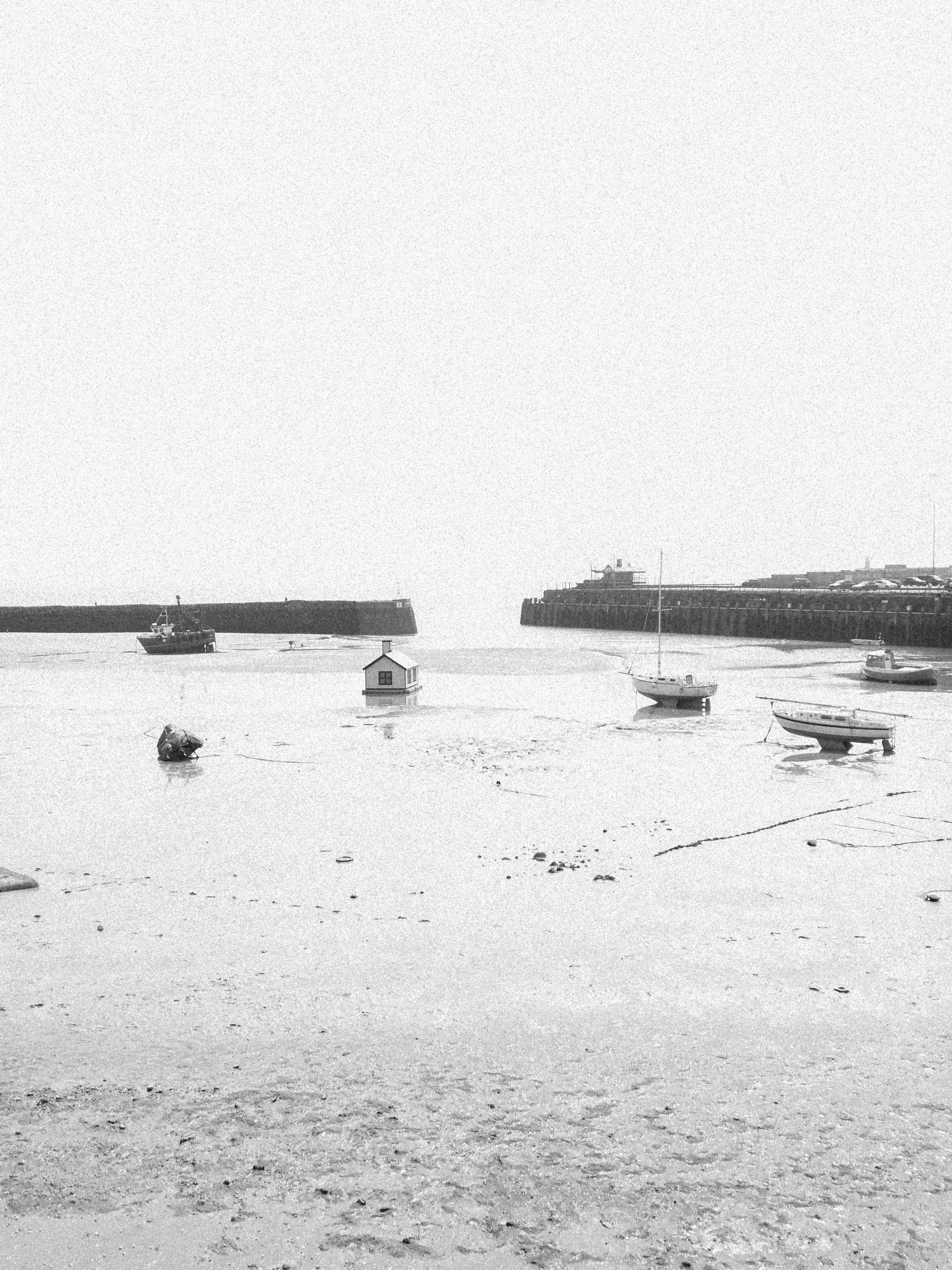 View over a bay with fishing boats while the tide is out