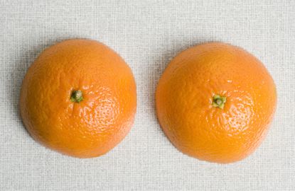 Two halves on an orange on a table, nipple orgasms