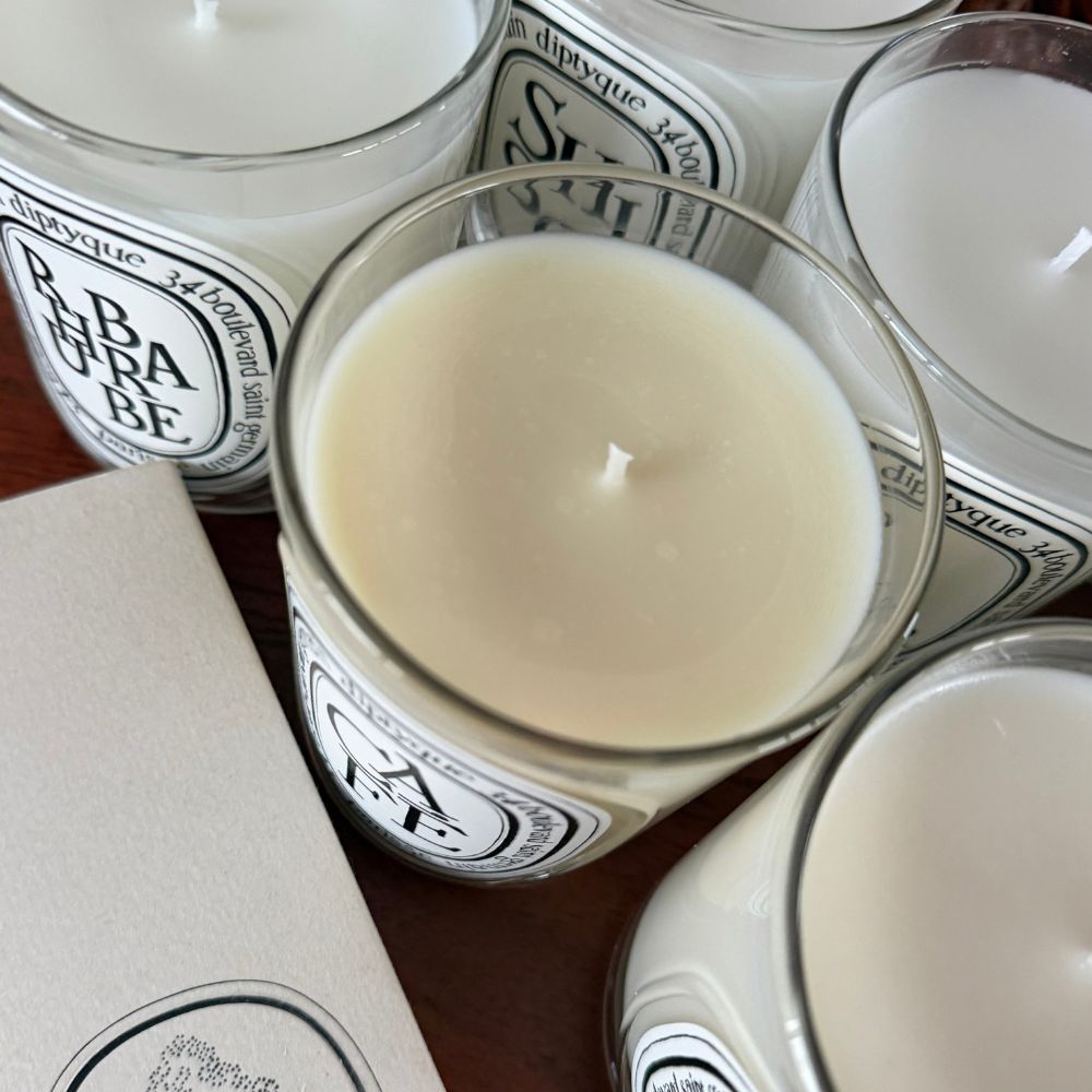 The best Diptyque candles as shot by Shannon Lawlor, collaged with a shot of Diptyque Lys candle shot by Emma Hoareau on her fireplace