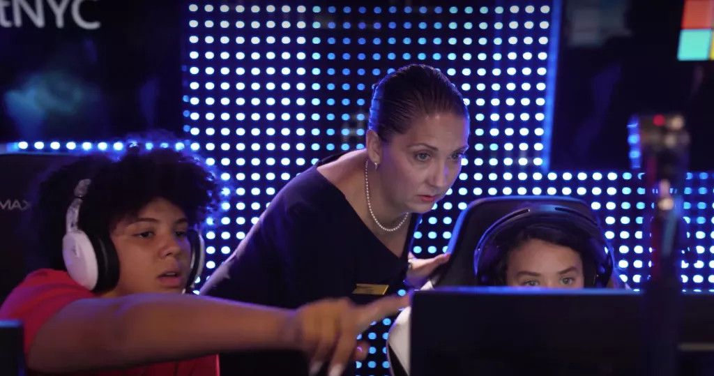 Lori Bajorek with two students at esports console