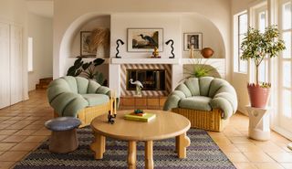 living room with tan leather chairs and gold accents