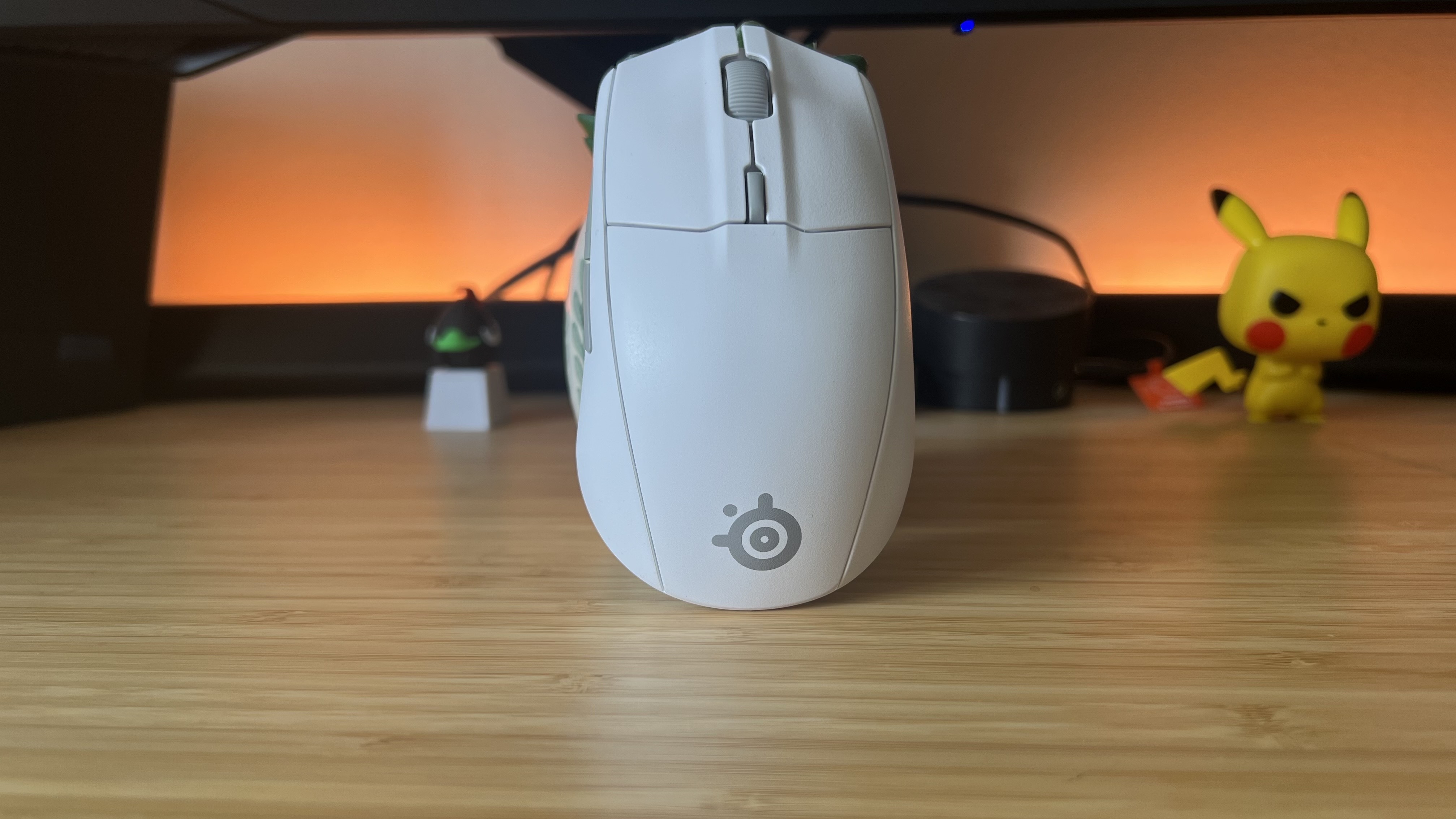 SteelSeries Rival 3 Wireless Gen 2 gaming mouse standing upright on a wooden desk