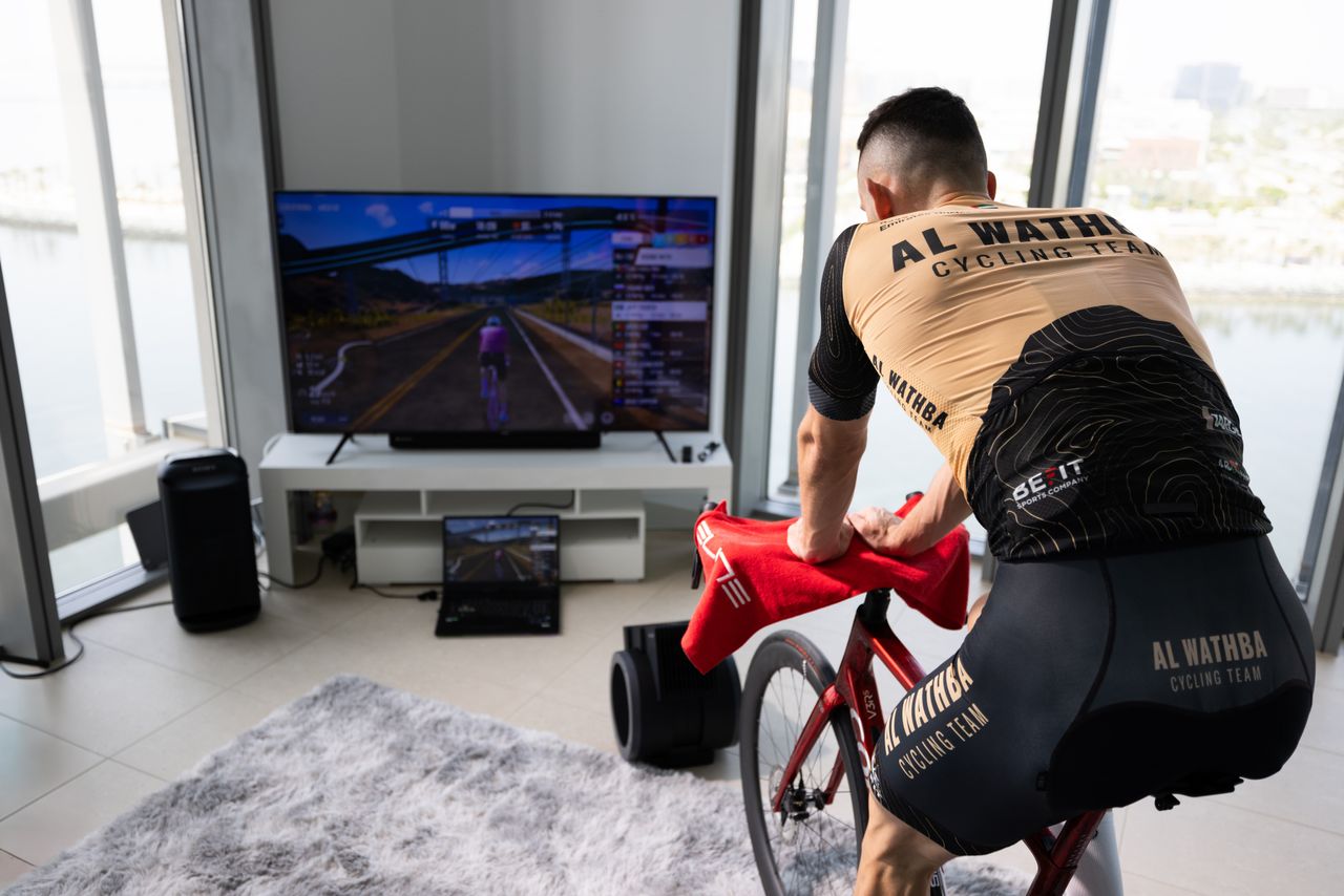 A male cyclist riding indoors using MyWhoosh
