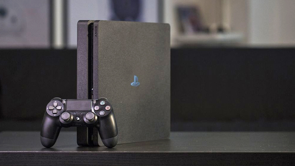 PlayStation 4 console and controller on a black table