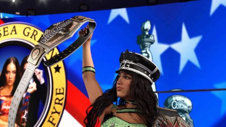 Chelsea green raises a belt as she enters the ring in WWE 2K26