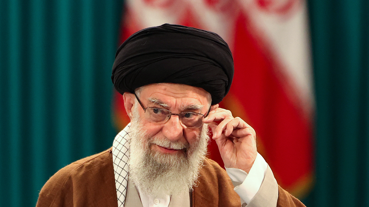 Ali Khamenei adjusts his eyeglasses at press conference