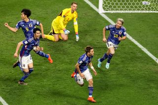 Japan players celebrate Doan Ritsu's goal against Germany at the 2022 World Cup.