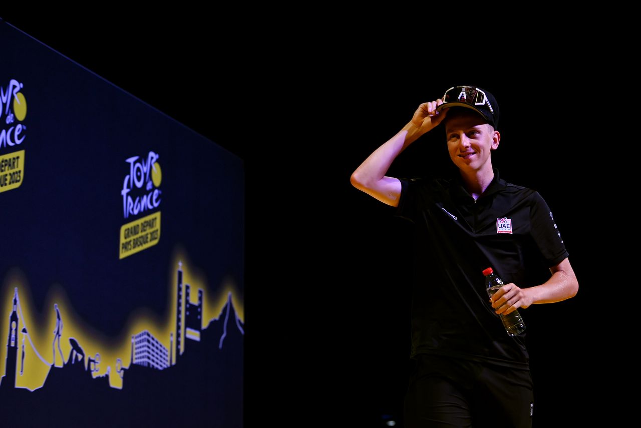 Tadej Pogacar greets journalists at a pre Tour de France press conference