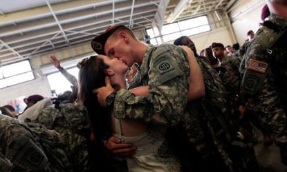 Sgt. Patrick Hopkins kisses his fiancee as he returns from a year-long tour in Iraq.