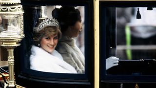LONDON - NOVEMBER 04: Princess Diana, Princess of Wales on her way to the State Opening of Parliament with Princess Anne on November 04 1981 in London, England. She is travelling in the Glass Coach used for her wedding.