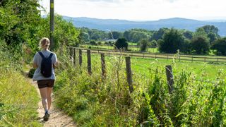 best walks in the Cotswolds: hiker in the Cotswolds