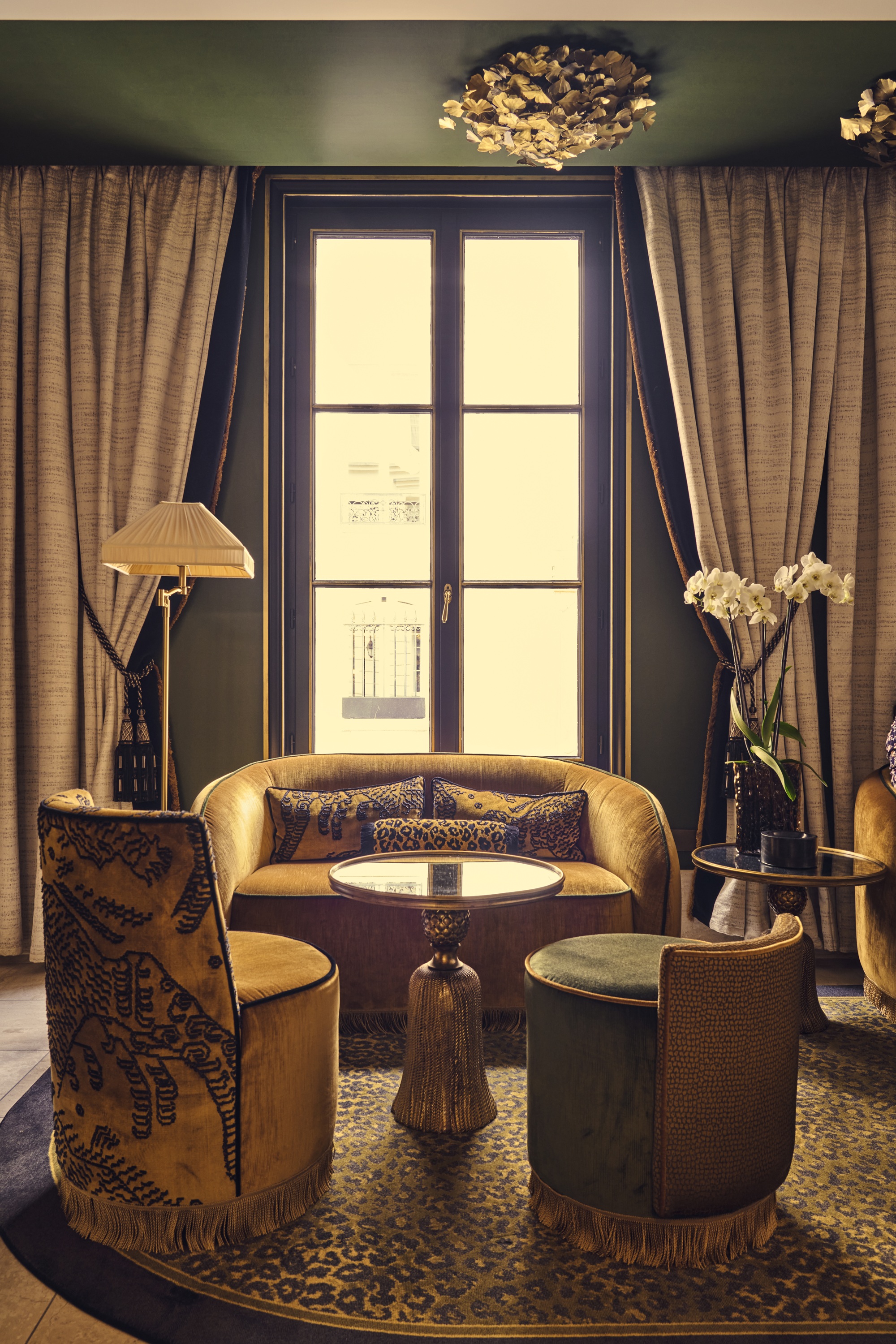 an art deco hotel lobby with leopard print motifs and amber colored sofa and chairs with fringed edging