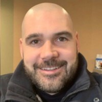 headshot of Matthew Grady a bald man with facial hair