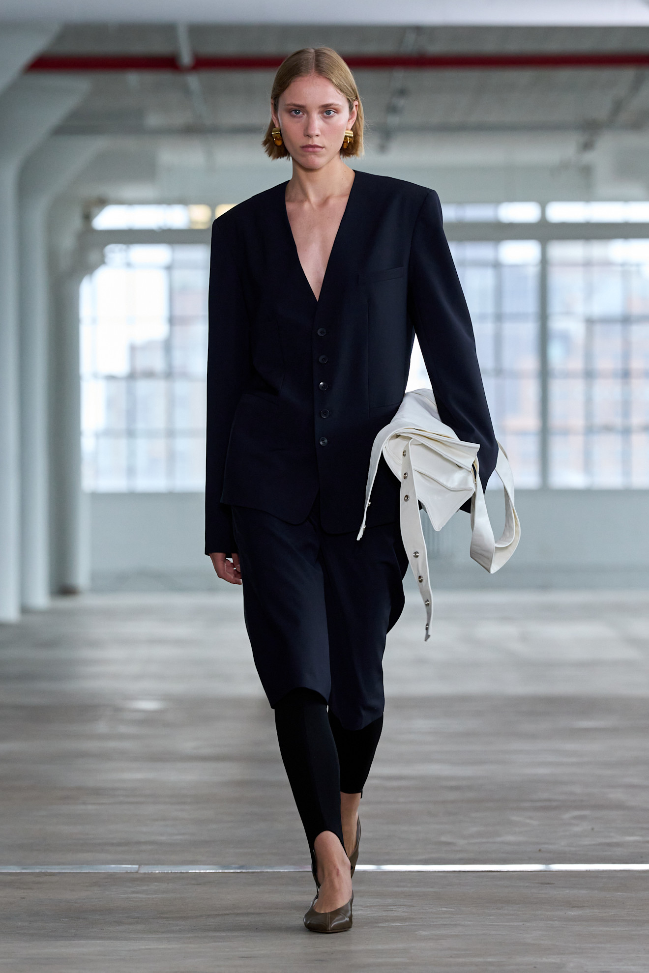 a model walks the spring 2025 Tibi runway wearing the legging layering trend