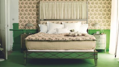 A traditional bed in a green bedroom