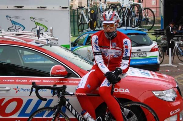 A Katusha rider keeps warm before their ride with the media