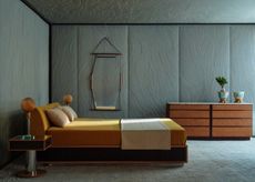 a light blue bedroom with a yellow bed