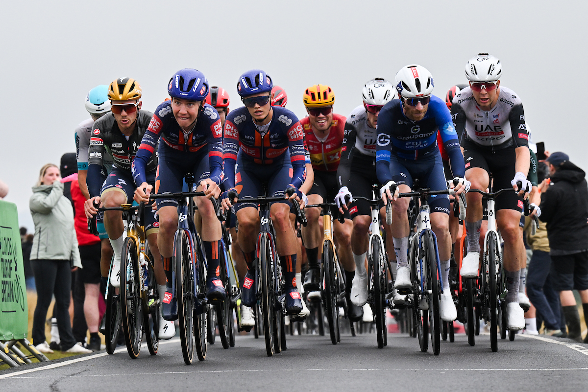 Team Picnic PostNL and Groupama-FDJ leading the peloton