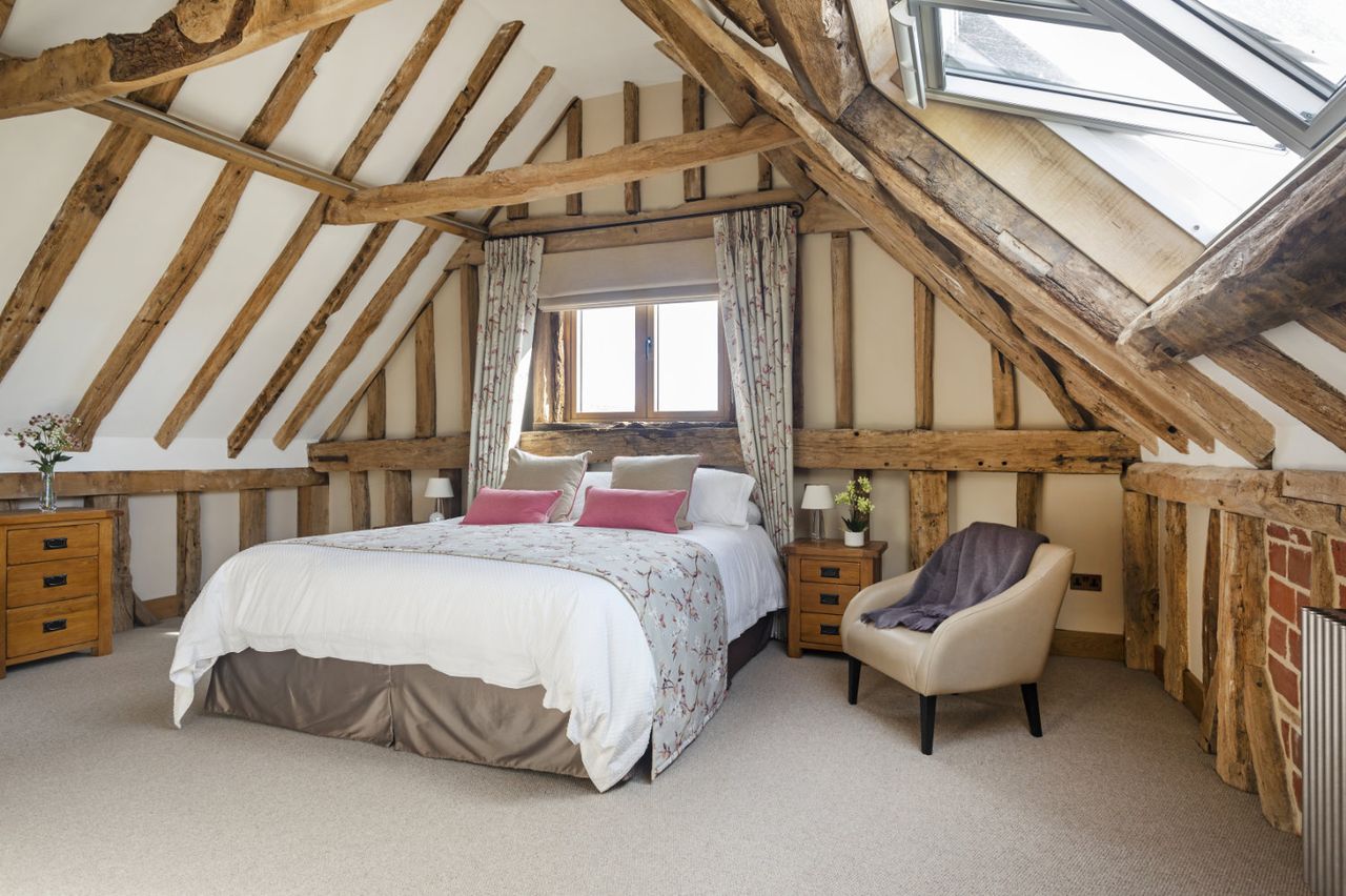 A bedroom with exposed beams